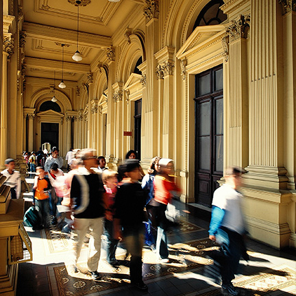 Group of people walking through one of the Monument-Building corridors.